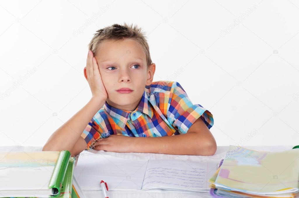 Tired school boy thinking about homework