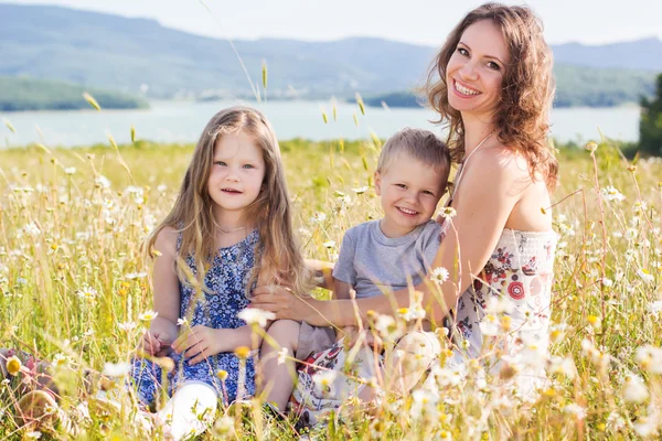 Mother outdoors with son and daughter — Stock Photo, Image