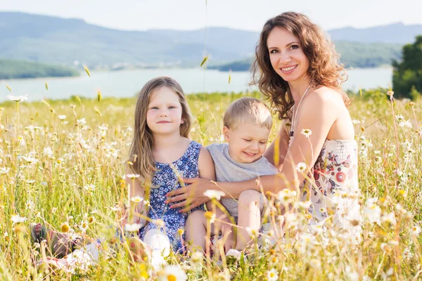 Mother outdoors with son and daughter — Stock Photo, Image