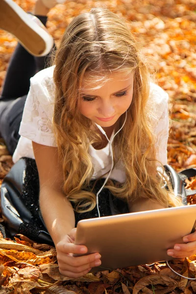 Ragazza adolescente con tablet digitale e cuffie — Foto Stock