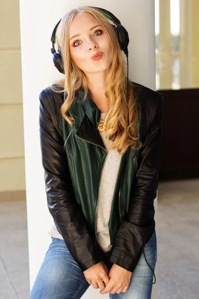 Young happy teenager is wearing headphones — Stock Photo, Image