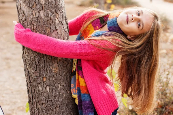 Happy child girl with fallen golden leaves — Stock Photo, Image