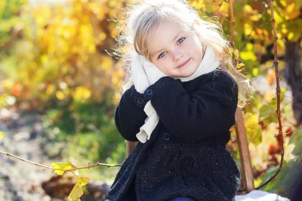 Adorable little girl in warm clothes, autumn time — Stock Photo, Image