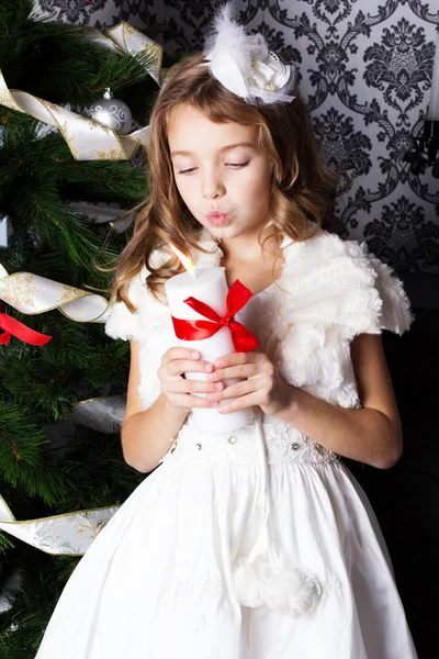 Little girl with Christmas candle — Stock Photo, Image