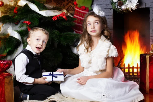 Happy children with christmas presents — Stock Photo, Image