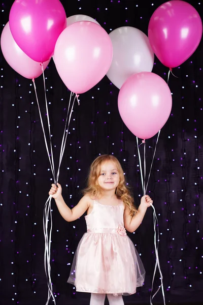 Little girl with pink balloons — Stock Photo, Image