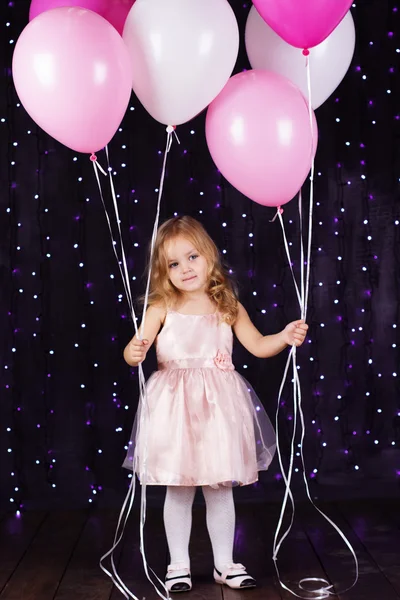 Little girl with pink balloons — Stock Photo, Image