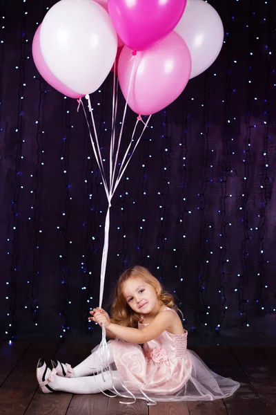 Little girl with pink balloons — Stock Photo, Image