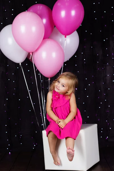 Little girl with pink balloons — Stock Photo, Image