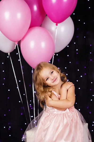 Little girl with pink balloons — Stock Photo, Image