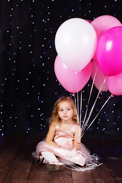 Little girl with pink balloons — Stock Photo, Image