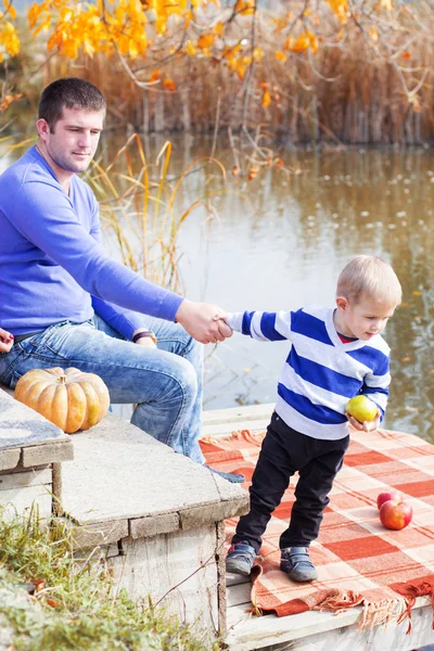 Young father with son near lake, autumn time — Stock Photo, Image