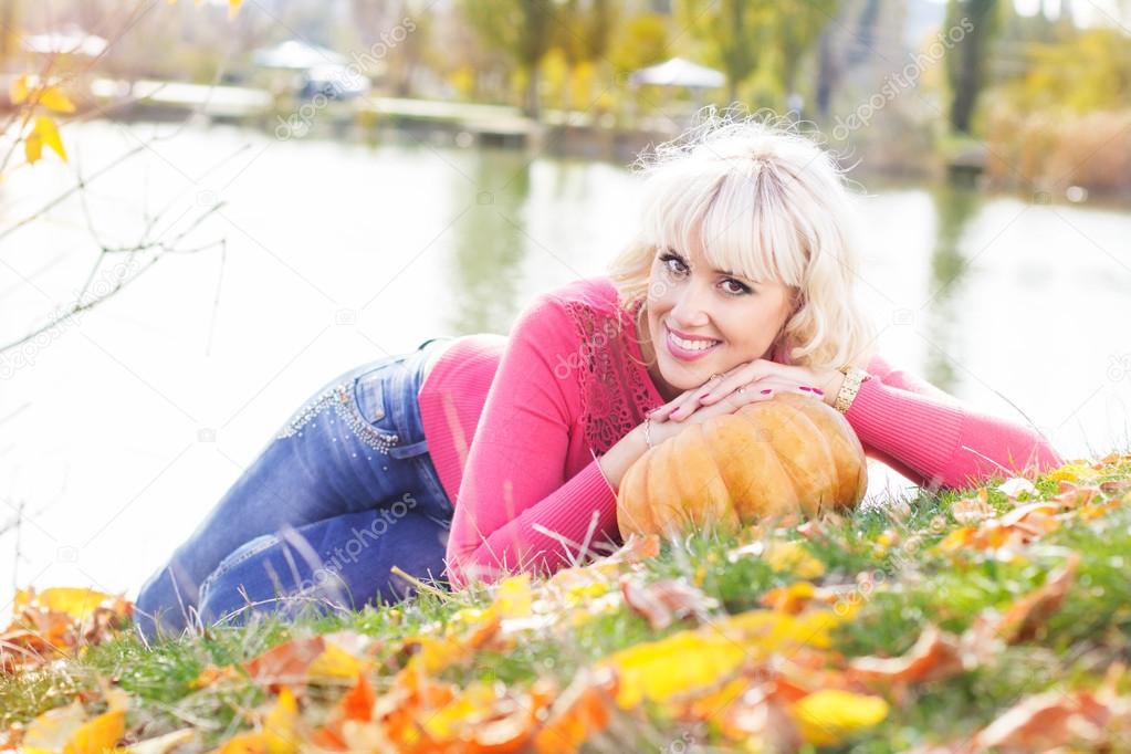 Young woman with pumpkin, autumn time