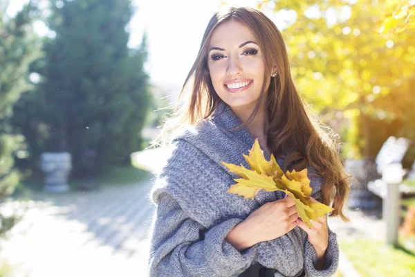 Young pretty teenager girl in autumn park — Stock Photo, Image