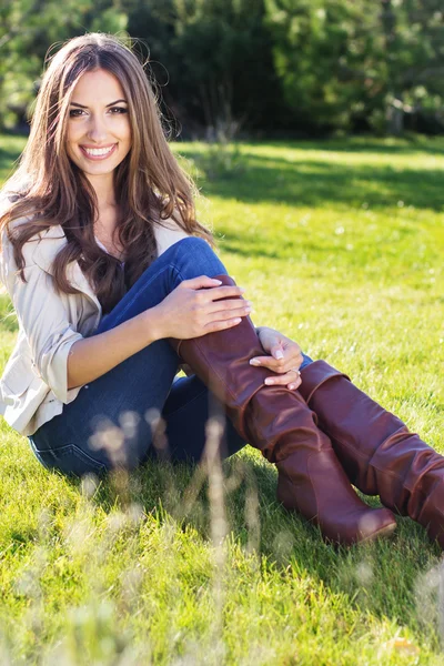 Young pretty teenager girl sitting on green grass — Stock Photo, Image