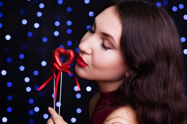 Beautiful woman holding red hearts — Stock Photo, Image