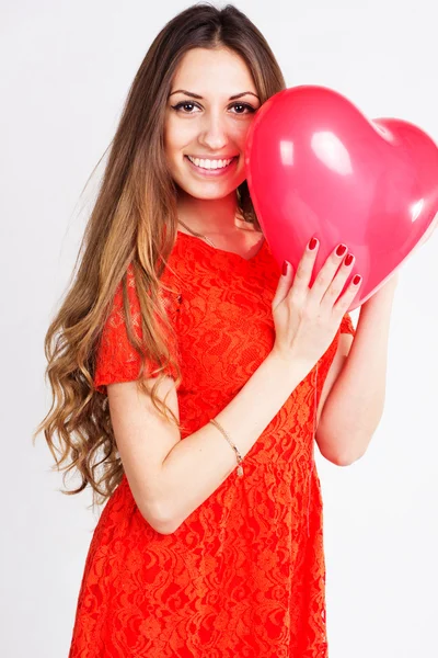 Woman holding red heart balloons — Stock Photo, Image
