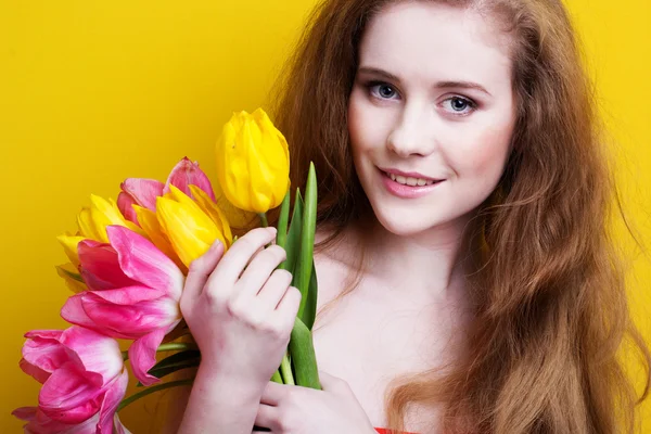 Beautiful redheared girl with bouquet of tulips — Stock Photo, Image