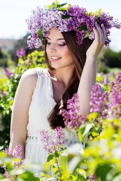 Menina bonita com flores lilás — Fotografia de Stock