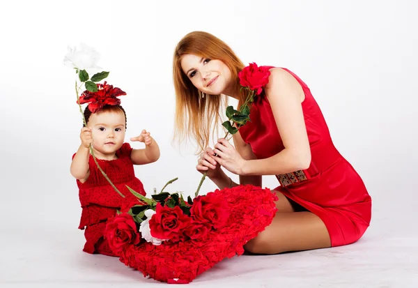 Happy mother and her daughter with big red heart — Stock Photo, Image