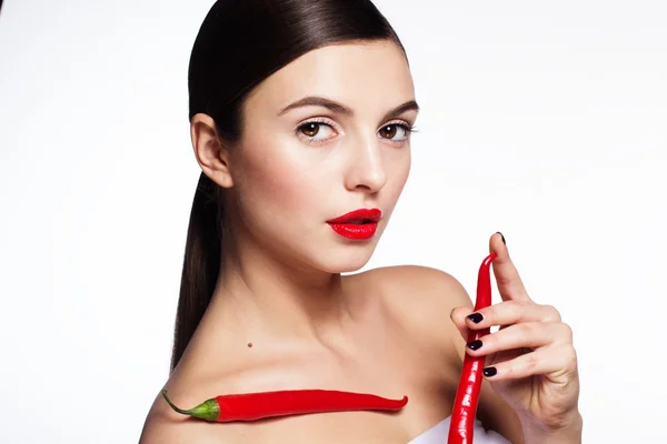 Beautiful girl with hot red chili peppers — Stock Photo, Image