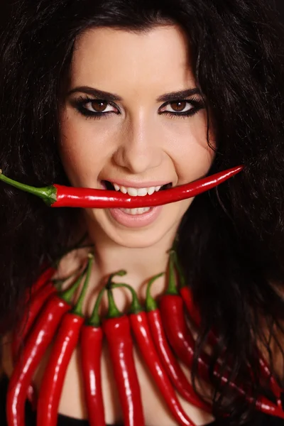 Sexy naked brunette girl with red cayennes peppers — Stock Photo, Image