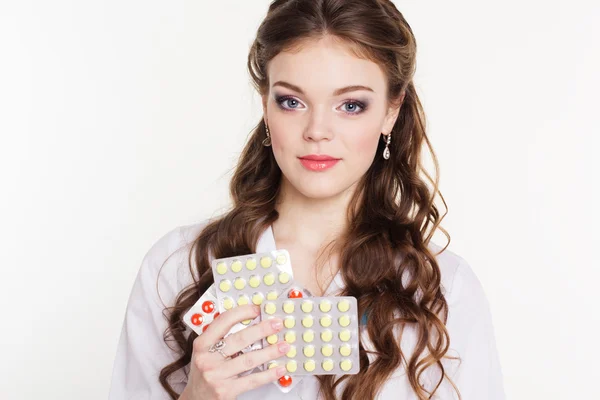 Pretty nurse with vitamins isolated on white — Stock Photo, Image