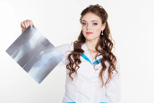 Young intern girl looking at the x-ray picture — Stock Photo, Image