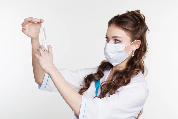 Young intern is practiced with syringe isolated on white — Stock Photo, Image