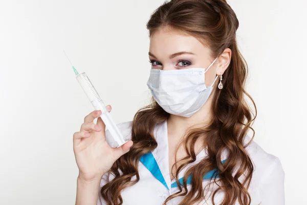 Nurse with syringe is wearing mask on white background — Stock Photo, Image