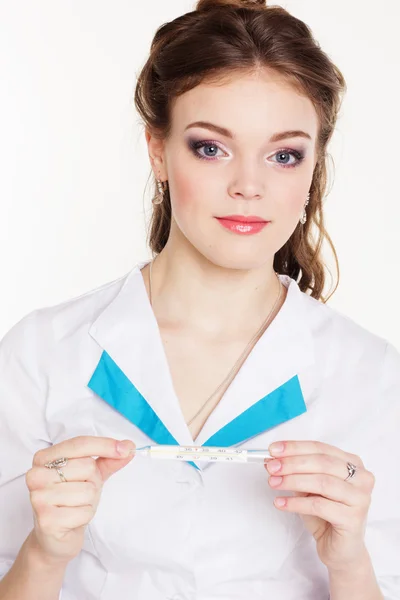 Pretty young female doctor with thermometer — Stock Photo, Image
