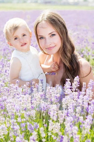 Mother and her child in field of lavender flowers — Stock Photo, Image