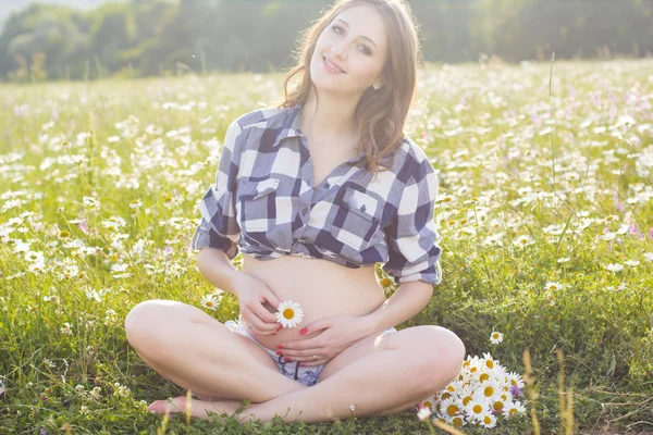 Mujer embarazada en luces de puesta de sol — Foto de Stock