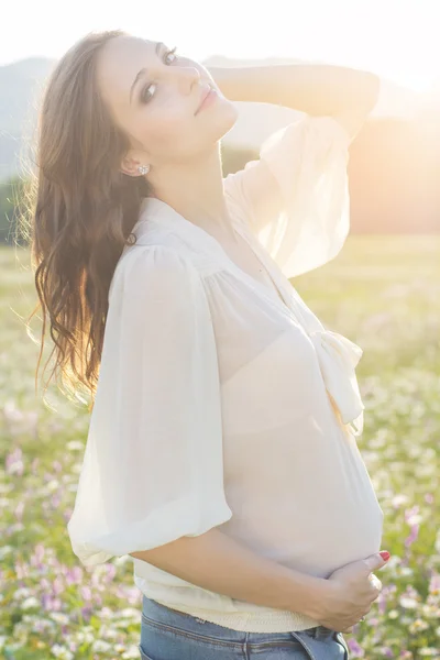 Pregnant woman in sunset lights — Stock Photo, Image