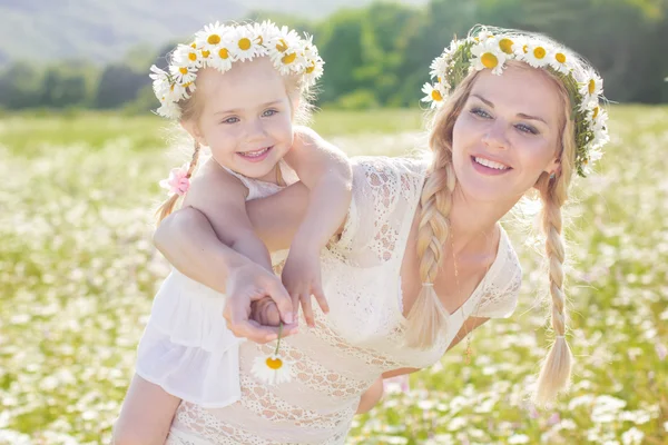 Família mãe e criança no campo de flores de margarida — Fotografia de Stock