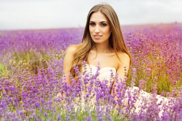 Pretty girl  at purple lavender field — Stok fotoğraf