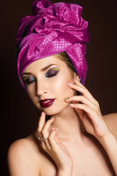 Beautiful girl with fashion purple turban on her head — Stockfoto