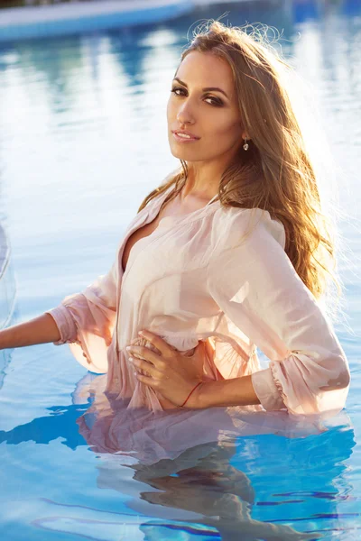 Sexig leende tjej bär sidenskjorta i poolen — Stockfoto