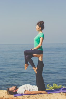 Çift acroyoga deniz kıyısında pratik vardır 
