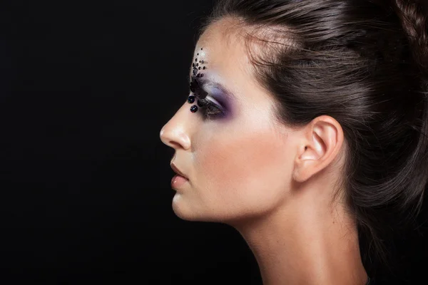 Profile portrait of girl with creative makeup — Stock Photo, Image