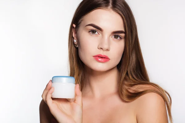 Pretty girl is holding jar of face cream — ストック写真