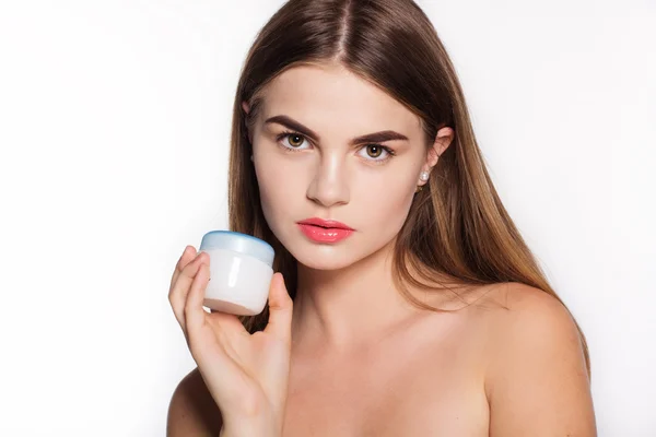 Pretty face of girl is holding white cream jar — Stock Fotó