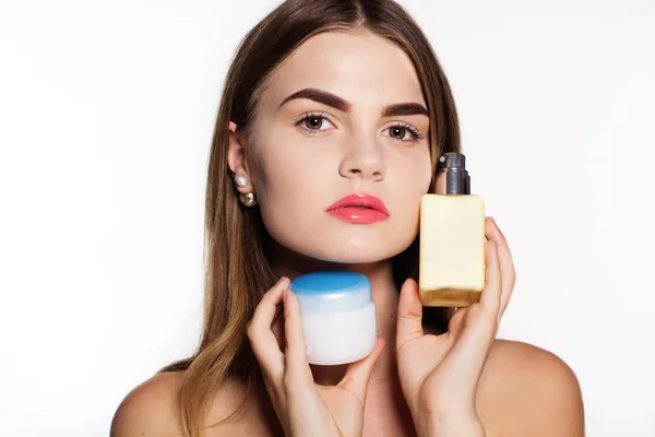 Girl is holding two jars with facial cream — Stockfoto