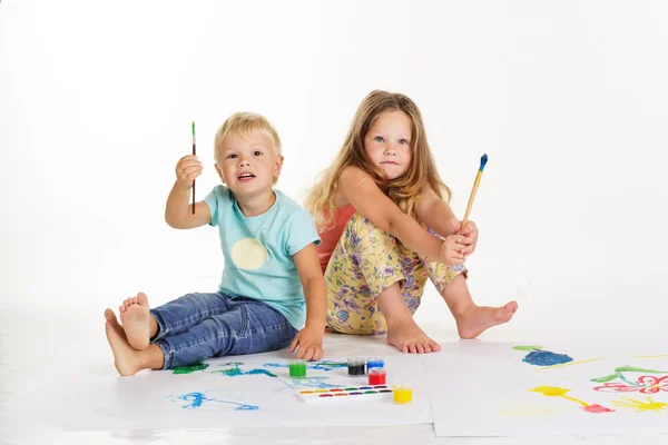 Menino e menina estão desenhando imagens por tintas — Fotografia de Stock