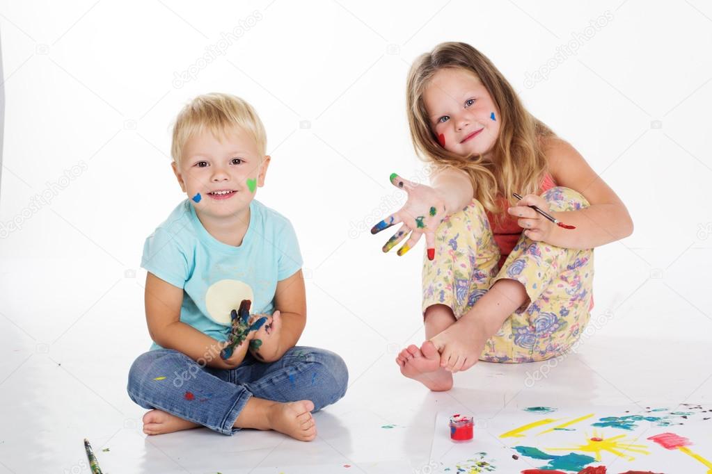 Boy and girl are drawing pictures by hands