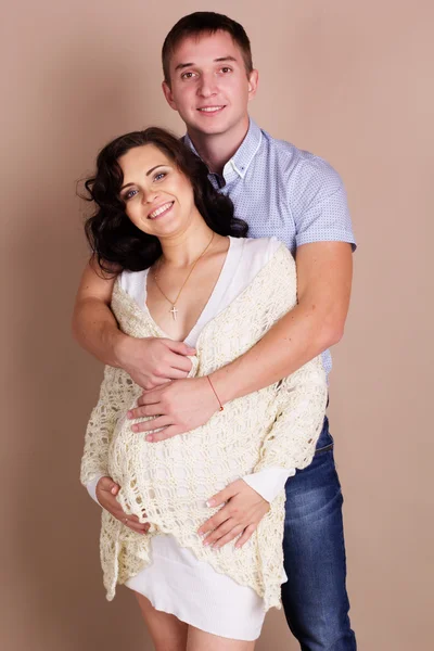 Happy smiling couple are posing in studio — Stock Photo, Image