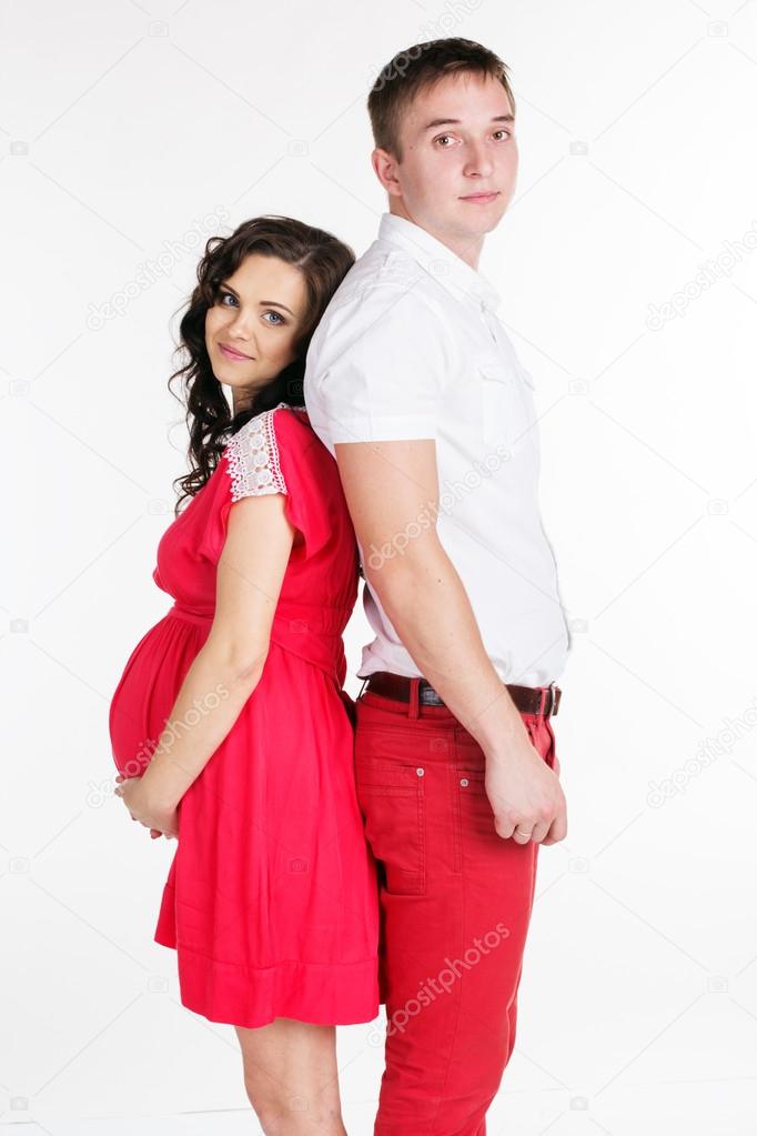 Pregnant girl and boy are wearing red clothes — Stock Photo ... Pregnant girl and boy are wearing red clothes — Stock Photo ...
