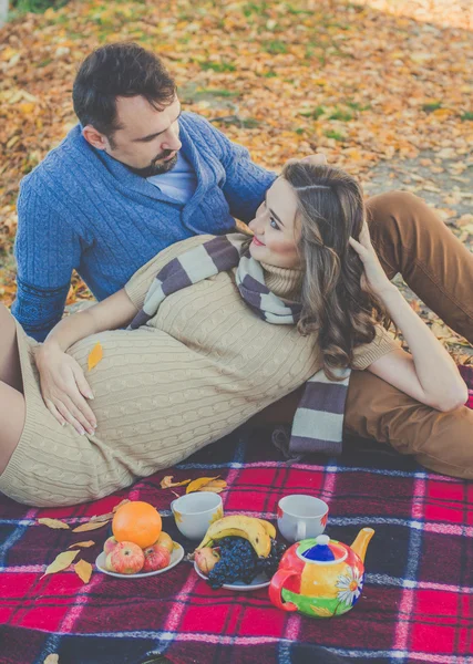 Happy future parents on the walk in autumn park — Stock Photo, Image