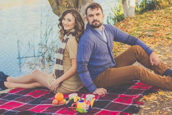 Happy young couple on the picnic near lake — Stock Photo, Image