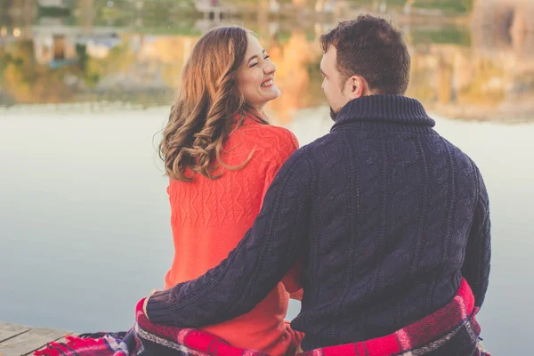 Happy man and woman are resting near lake — Stock Photo, Image